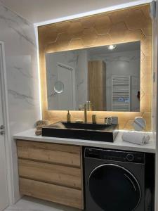 a bathroom with a sink and a mirror at Appartement de Luxe in Villepinte +27 photos