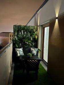 a balcony with a couch and a green plant at Appartement de Luxe in Villepinte