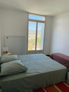 a bedroom with a large bed with a large window at Blue Paradise in La Ciotat