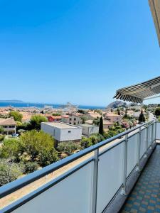 a balcony with a view of a city at Blue Paradise in La Ciotat