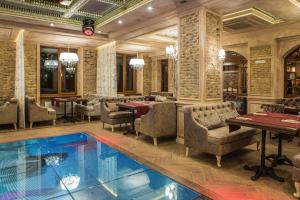 a pool in a restaurant with tables and chairs at Hotel Shengen "Шенген" in Kropyvnytskyi