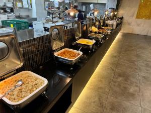 a buffet line with many different types of food at JK Blossom Hotel in Seoul