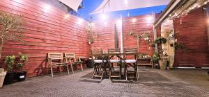 a wooden wall with chairs and tables in a restaurant at Cat on a Hot Tin Roof in Yangyang