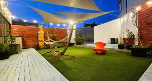 a patio with a hammock and an umbrella at Cat on a Hot Tin Roof in Yangyang