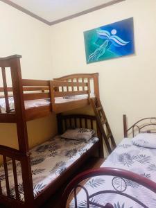 a room with two bunk beds and a picture on the wall at Perlies Inn Balcony House in Tanay