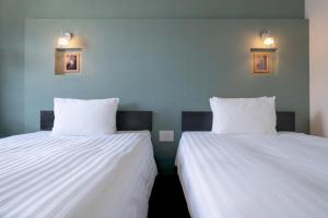 Postel nebo postele na pokoji v ubytování Hotel Vista Atsugi