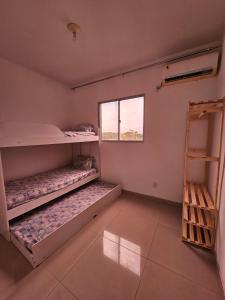 a room with two bunk beds and a window at Marques Beach House MCZ in Maceió +11 photos