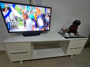 a flat screen tv sitting on top of a white entertainment center at Marques Beach House MCZ in Maceió