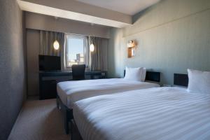 Postel nebo postele na pokoji v ubytování Hotel Vista Atsugi