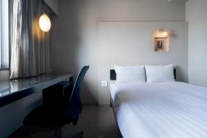 Postel nebo postele na pokoji v ubytování Hotel Vista Atsugi