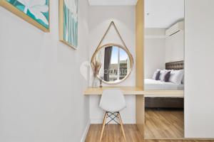 a bedroom with a mirror and a bed at Dahayu by Kozystay - Paskal in Bandung +23 photos