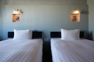 Postel nebo postele na pokoji v ubytování Hotel Vista Atsugi