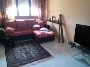 a living room filled with furniture and a tv at Sweet Sardinia Apartment in Elmas