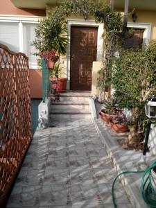 a walkway leading to a house with a patio at Sweet Sardinia Apartment in Elmas