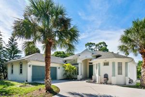 a house with palm trees in front of it at Mins To Florida White Sand Beach Villa Heated Pool in Nokomis