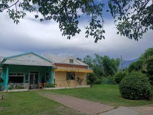 a house with a green and yellow house at 十畝田山莊 in Chishang