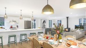 een eetkamer en woonkamer met een tafel en stoelen bij Coachwood Cottage in Robertson