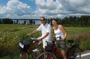 un hombre y una mujer sentados en sus bicicletas en Norrqvarn Hotell en Lyrestad