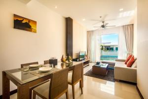 a living room with a dining table and a couch at Krabi Luxury Penthouse in Klong Muang Beach