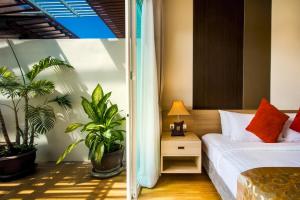 a bedroom with a bed and potted plants at Krabi Luxury Penthouse in Klong Muang Beach +16 photos