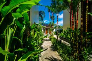 a path through a garden with palm trees at Krabi Luxury Penthouse in Klong Muang Beach