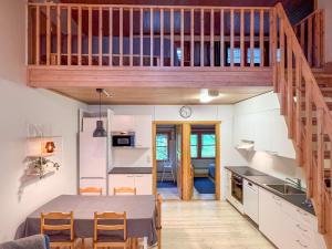 a small kitchen and dining room with a table in a tiny house at Lomakivakka - Roomy 2BD & loft by the lake, free wifi and sauna in Ruka