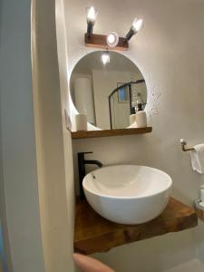 a bathroom with a white sink and a mirror at Urban Oasis in Târgu-Mureş