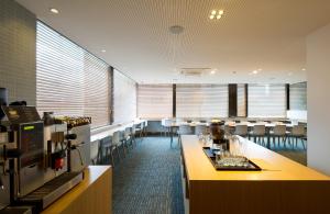 a restaurant with chairs and a bar with wine glasses at Metro Hotel Myeongdong in Seoul