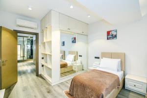 a bedroom with a bed and a mirror at Park Azure Deluxe Home 526 in Baku +67 photos