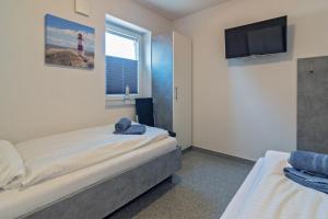 Postel nebo postele na pokoji v ubytování Ferienhaus Empora