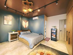 a bedroom with a bed and a refrigerator in it at The Shilla Apartment in Hanoi