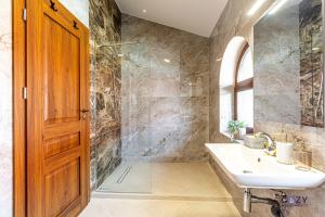 a bathroom with a sink and a shower at Cozy Brand New Boutique ApartHotel Brasov in Braşov +136 photos