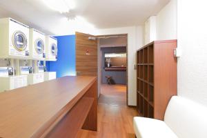 a room with a large wooden table in a room at HOTEL MYSTAYS Otemae in Osaka