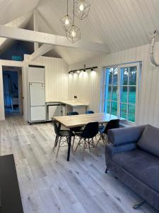 a living room with a table and a couch at Melluži tiny house 60m2 in Jūrmala