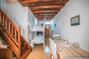 a room with a staircase and a bunk bed at Κυκλαδίτικη Μεζονέτα in Kithnos