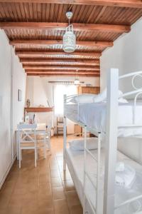 a room with two bunk beds and a table at Κυκλαδίτικη Μεζονέτα in Kithnos