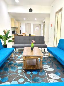 a living room with blue couches and a coffee table at MiriTimesSquare DAJ#4 Free WI-FI in Miri