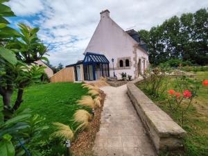 a small white house with a blue roof at Au Pti' Bonheur in Saint-Coulomb