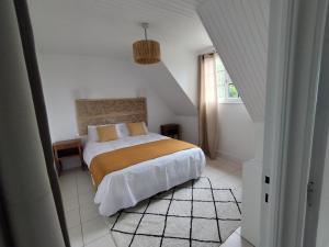 a bedroom with a bed in a white room at Au Pti' Bonheur in Saint-Coulomb +17 photos