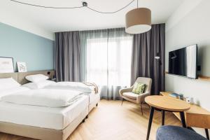 Posteľ alebo postele v izbe v ubytovaní harry's home Lienz hotel & apartments