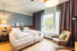 Posteľ alebo postele v izbe v ubytovaní harry's home Lienz hotel & apartments