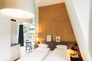 Posteľ alebo postele v izbe v ubytovaní harry's home Lienz hotel & apartments
