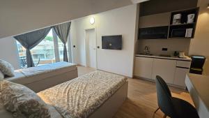 Postel nebo postele na pokoji v ubytování Richi Rooms & App
