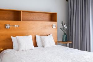 Posteľ alebo postele v izbe v ubytovaní Apartamenty Muzeum II Wojny Światowej