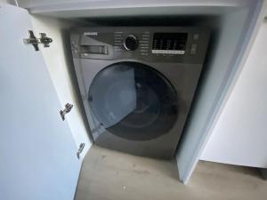 a washing machine sitting inside of a room at 2505 Studio in Central Cape Town, Wi-Fi, pool, free parking in Cape Town