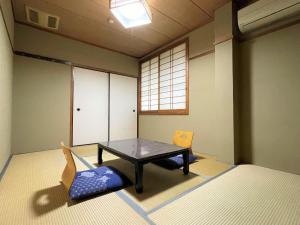 Postel nebo postele na pokoji v ubytování Dochu Land Shin Onsen