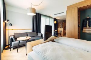 Posteľ alebo postele v izbe v ubytovaní harry's home Lienz hotel & apartments