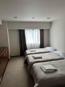 Postel nebo postele na pokoji v ubytování Sapporo Oriental Hotel
