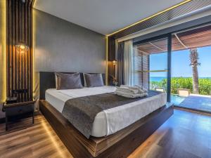 A bed or beds in a room at Adora Calma Beach Hotel Adults Only