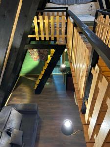 a living room with wooden stairs and a couch at Cottage Sataplia in Kutaisi